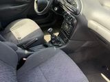 the interior of a small car with a steering wheel and dashboard