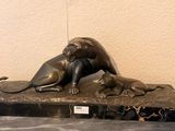 a statue of a dog and a cat on a marble base