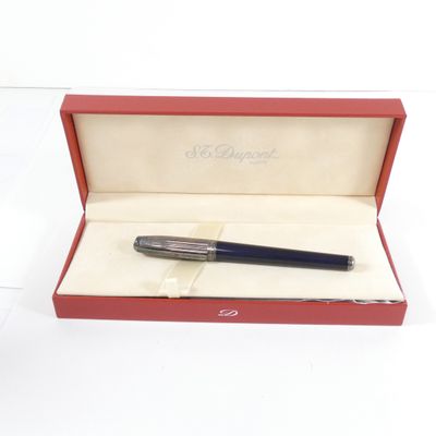 un stylo dans une boîte rouge posée sur une surface blanche