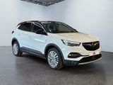 a white opel parked in a white room with a black floor