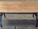 a wooden table with metal legs and a wooden top