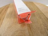 an orange box on a wooden table with a white top