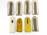 six pieces of metal with yellow and grey paint on them