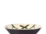 a black and white bowl sitting on top of a table