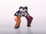 a figurine of a man and a woman holding hands