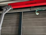 a red beam hanging from the ceiling of a building