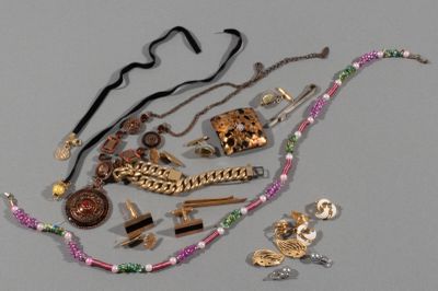 a lot of jewelry that is laying out on the table
