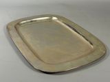 rectangular silver plate on white table with silver rim