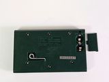 a green electronic device that is sitting on a table