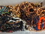 a white container filled with lots of beads and bracelets