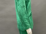 an image of a mannequin wearing a green dress and hat