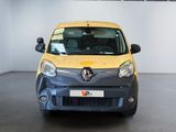 a small yellow car parked in a large room