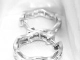 two rings that are sitting on a white cloth