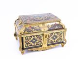a gold and black box with flowers and birds on it