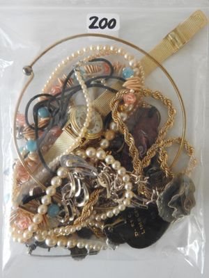 a bag of assorted jewelry in it on a table