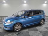 a blue volkswagen touran parked on a checkered tile floor