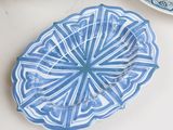 a blue and white plate sitting on a table next to a cup of coffee