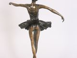 bronze statue of a woman in a tutu on a pedestal
