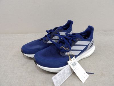a close up of a pair of adidas running shoes on a white surface
