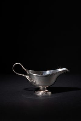 a silver gravy on a black background