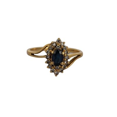 a close up of a gold ring with a blue stone