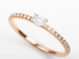 a gold ring with a baguet of diamonds on top of it