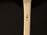 a close up of a spoon on a table with a black background