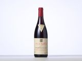 a bottle of red wine sitting on top of a table