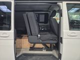 a seat in the back of a van with a tv in it