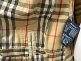 a white toilet sitting next to a checkered shirt