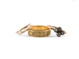 a close up of two gold rings with a black diamond on them