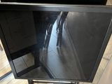 a flat screen tv sitting on a stand in a room