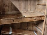 a wooden cabinet with a drawer underneath it