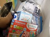 a pile of children ' s toys in a cardboard box