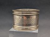 an image of a silver ring on a clear pedestal