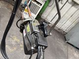 a power cord connected to a phone in a garage