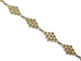 a close up of a gold bracelet on a white background