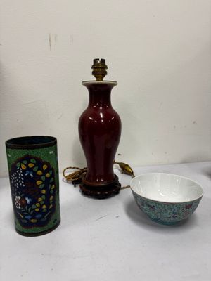 two vases, a bowl, and a lamp on a table
