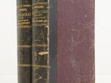 an old pair of books sitting next to each other on a white surface