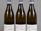 trois bouteilles de vin posées sur une table l'une à côté de l'autre