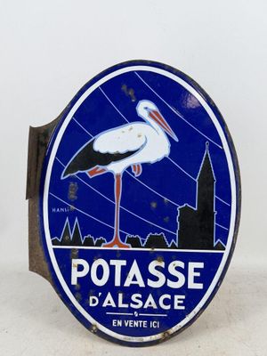 a blue and white sign with a stork on it