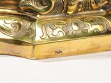 a gold statue of a person sitting on top of a table