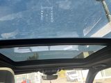a view of the sunroof from inside of a car