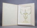 an open book with a drawing of a vase in it