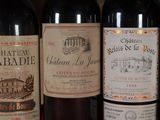 several bottles of wine are lined up on a shelf