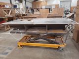 a table that is sitting on a dolly in a room