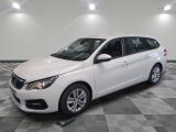 a picture of a white car that is parked in a garage