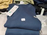 a lot of folded shirts on a table in a store