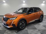 the orange suv is parked in a large room with a checkered floor