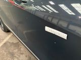 a black car with a sticker on the side of it